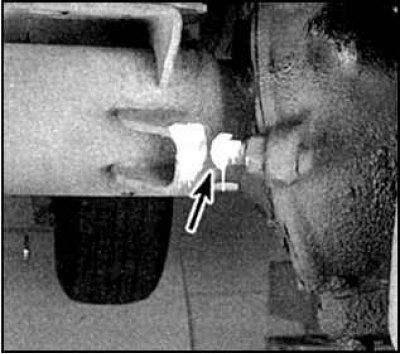 Болт ограничителя поворота колес смазывается литолом. Место смазки (указано стрелкой).